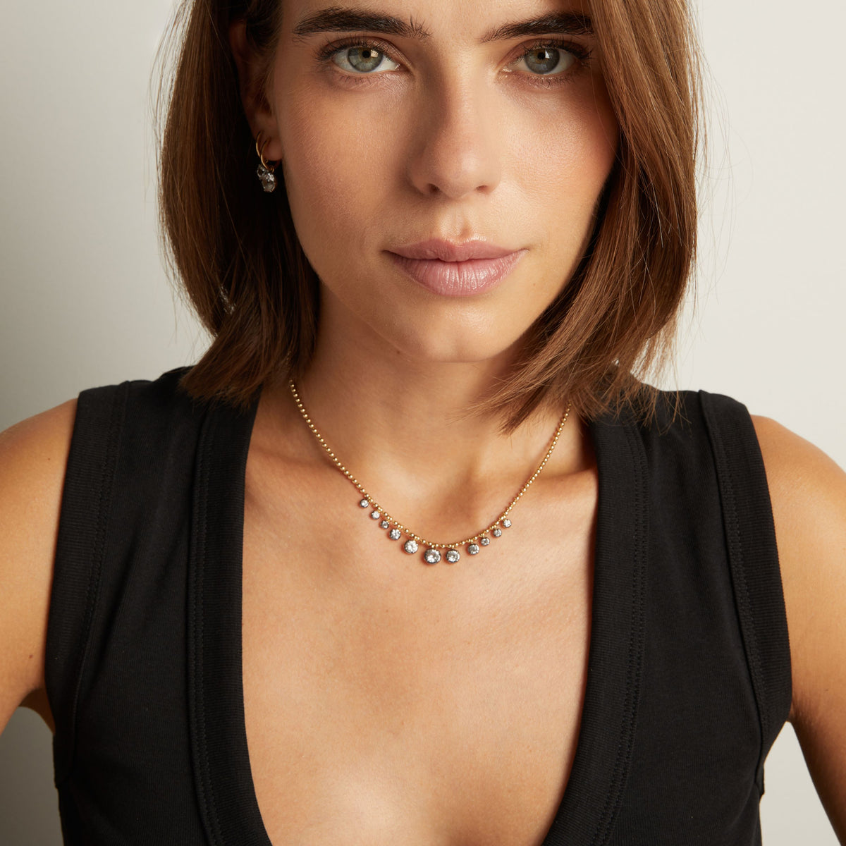 Model. Close up of woman wearing a Graduated Georgian Chain Necklace on neutral background.