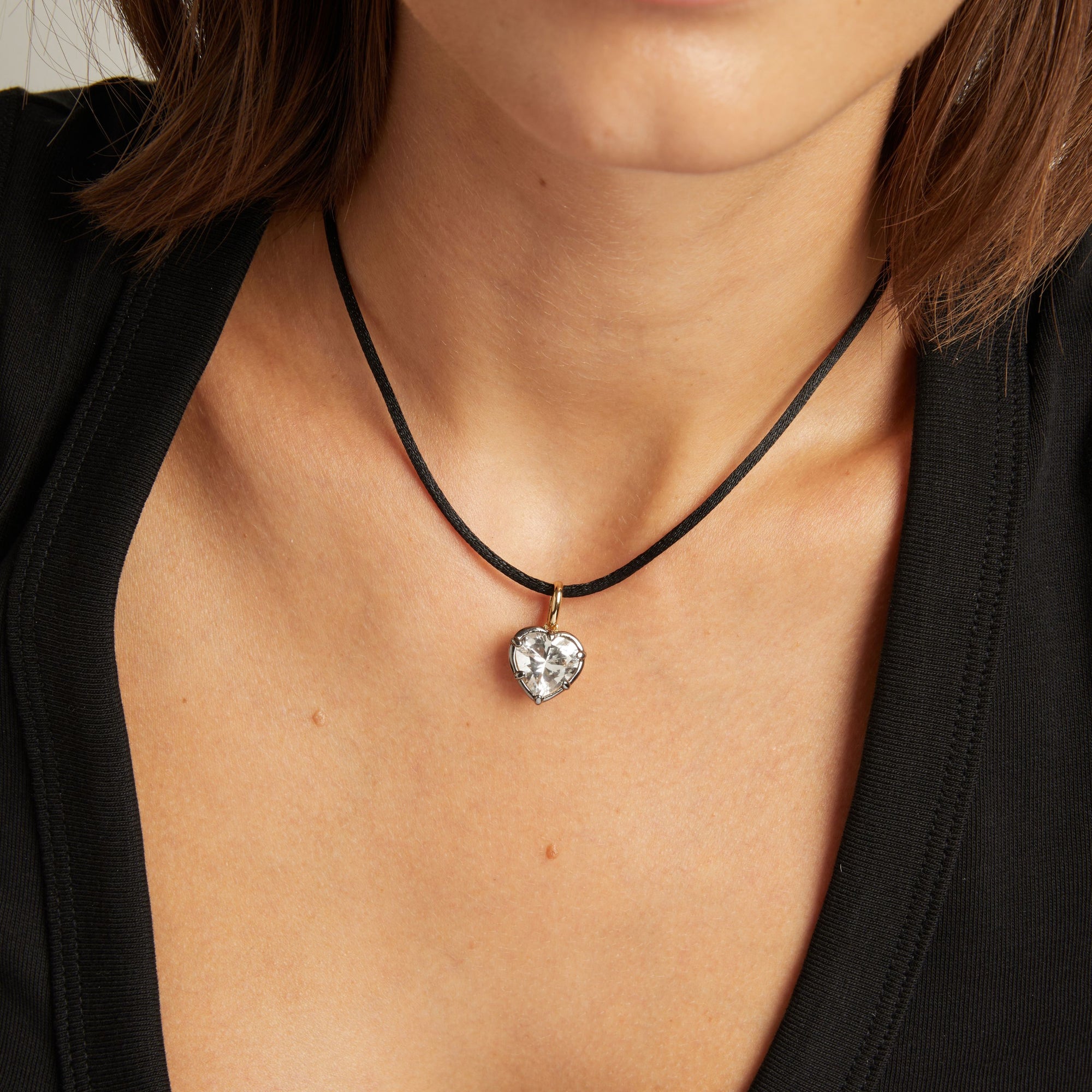 Close up of woman wearing a Heart Georgian Pendant on a black nylon cord