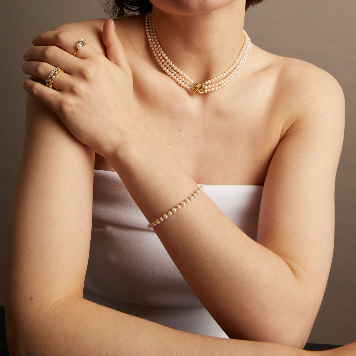 Pearl knot bracelet and matching necklace on woman. Model