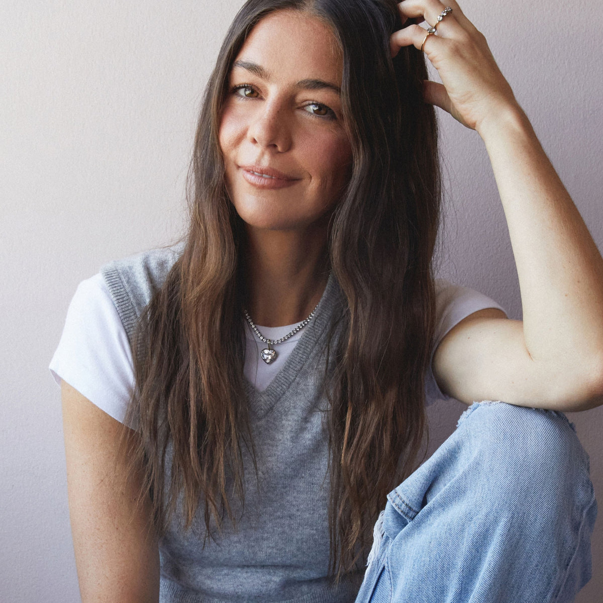 Model. A woman wearing a Heart Georgian Pendant on a tennis necklace on a neutral background.