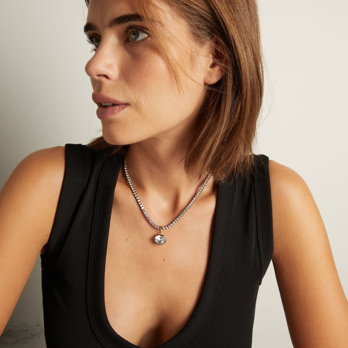 Model. Close up of woman wearing an Oval Georgian Pendant on a tennis necklace