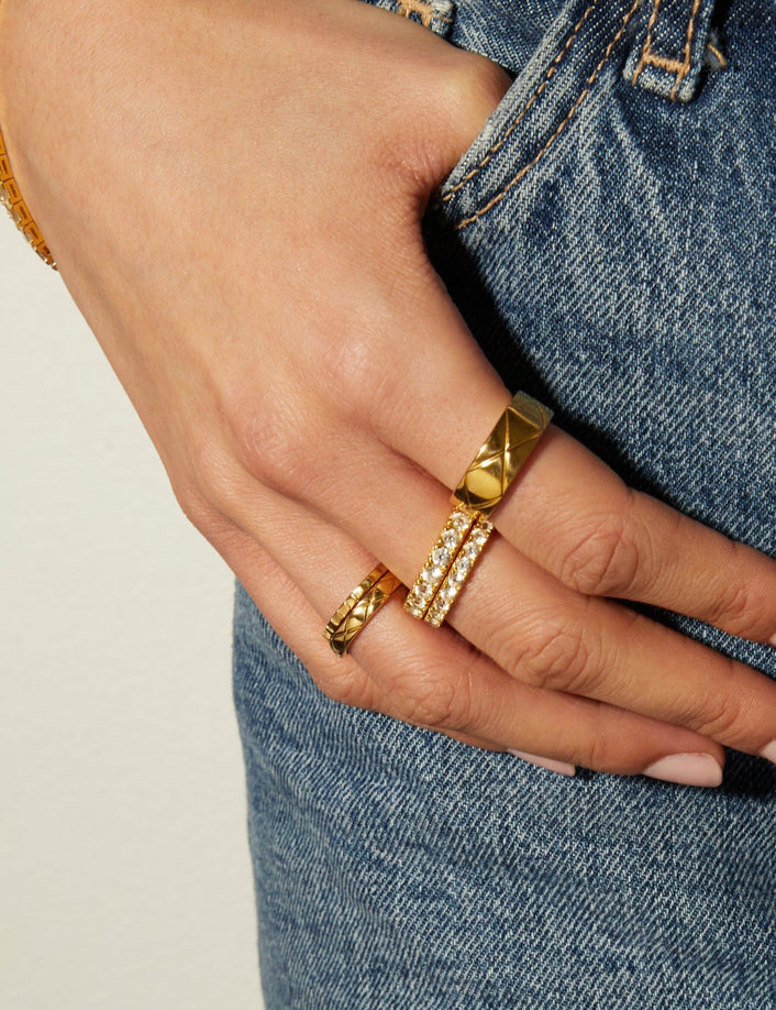 Lifestyle Model close up of woman with her thumb in her pocket wearing multiple rings 