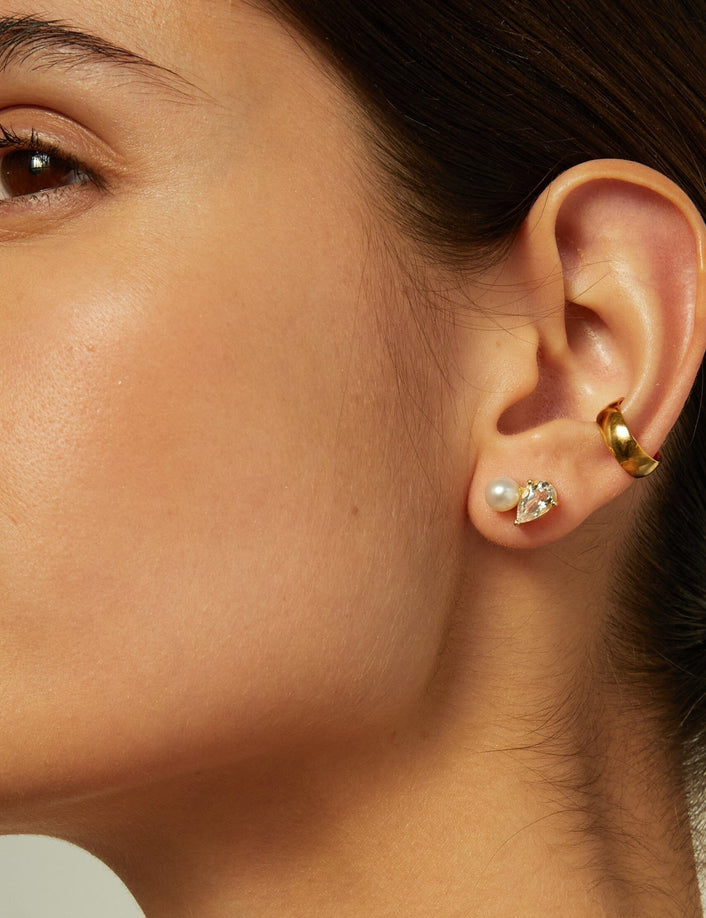 Lifestyle Model side profile of woman wearing multiple earrings 