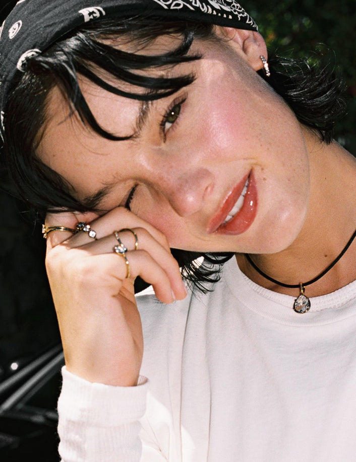 Model. Close up of woman wearing a Pear Georgian Pendant on a black nylon cord with a bandana on her head. 