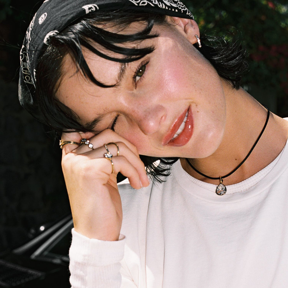 Model. Close up of woman wearing a Pear Georgian Pendant on a black nylon cord with a bandana on her head. 