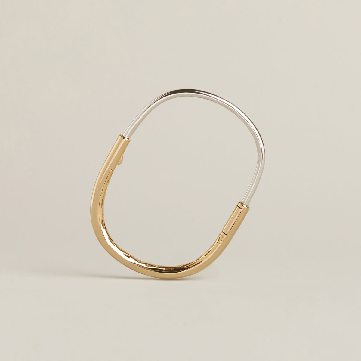 Model. A two toned latch bracelet on neutral background