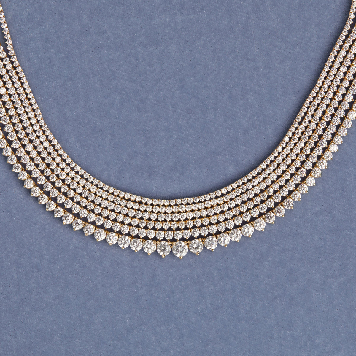 Model. Six diamond tennis bracelets on blue background