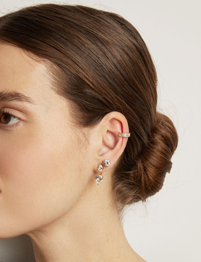 Model. woman wearing a diamond ear cuff and diamond earrings 