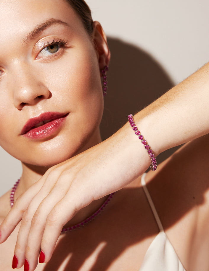 Woman wearing pink stone bracelet 