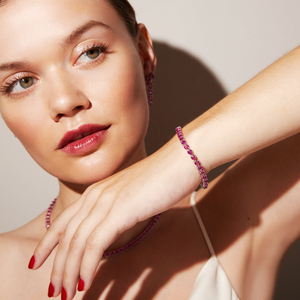 Woman wearing pink stone bracelet 