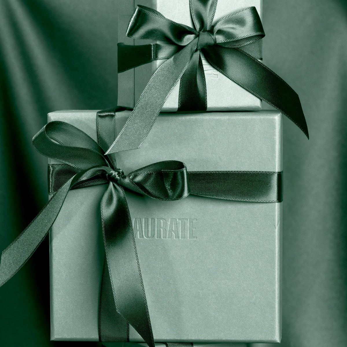 Two gift boxes with black ribbons on a dark background Model