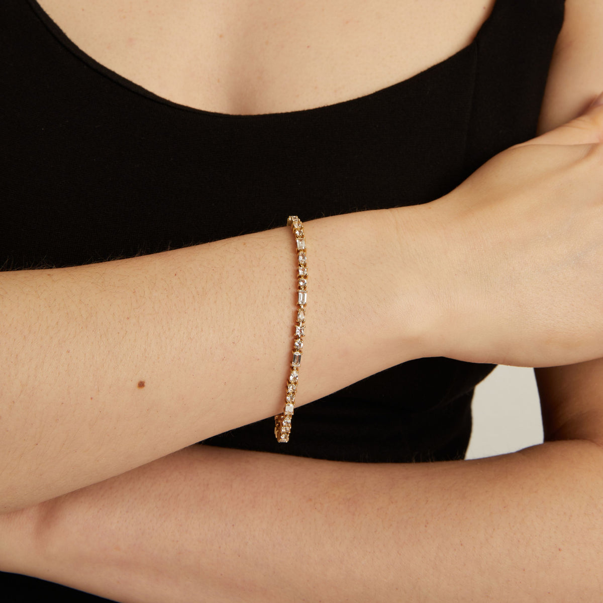 Model. Close up of a mixed shape tennis bracelet on wrist