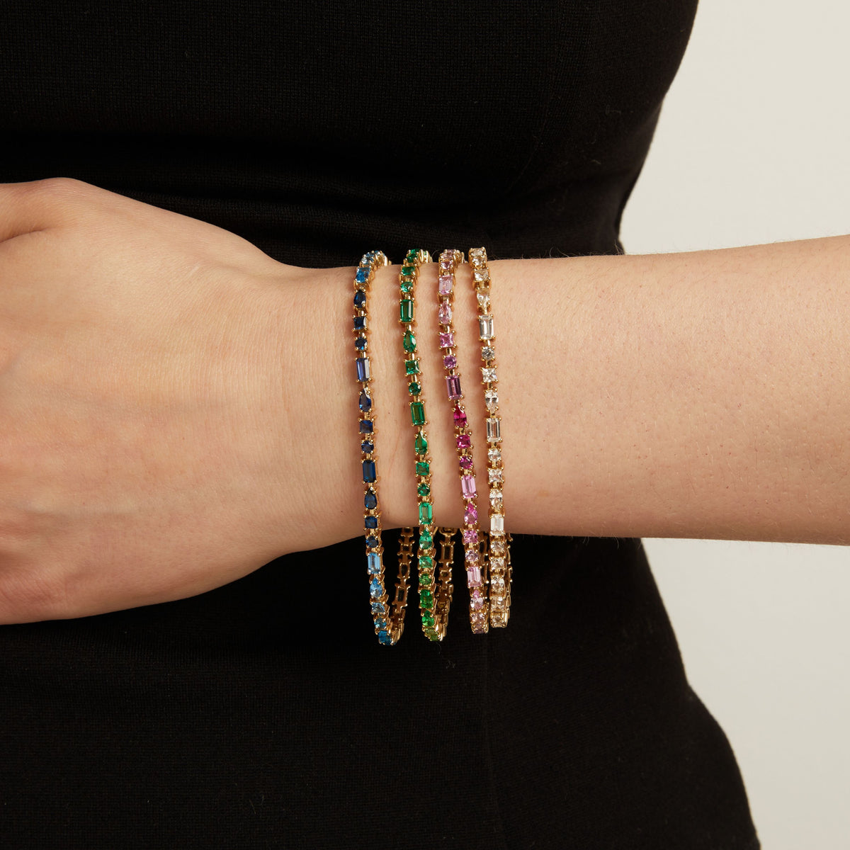 Model. Four colorful tennis bracelets on a person