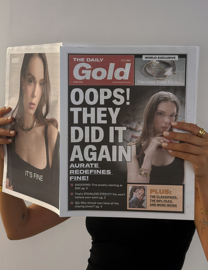 Model. Woman holding a tabloid over her face on a neutral background.