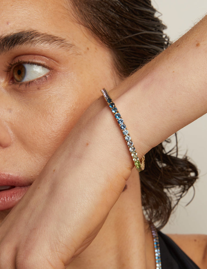 Model. Close-up of a woman wearing colorful beaded bracelets on her wrist.