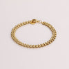 Video of a gold chain bracelet on white background.