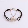 Video of silver watch with black rope band on white background