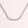 Video of white sapphire tennis necklace on white background.