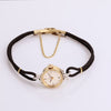 Video of black cord gold watch on white background