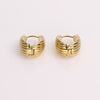 Video of gold hoop earrings on white background.
