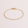 Video of gold chain bracelet on white background.
