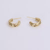 Video of gold hoop earrings on white background.