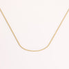 Video of gold chain necklace on white background.