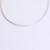 Grey cord necklace on neutral background