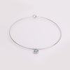 Video of gold collar necklace with gemstone pendant on white background.