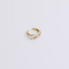 Gold huggie with gemstone on neutral background