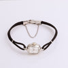 Video of black cord watch with silver face on white background
