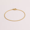 Video of gold chain bracelet on white background.