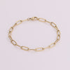 Video of gold chain bracelet on white background.