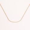 Video of gold chain necklace on white background.
