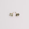 Video of green gemstone stud earrings on white background.