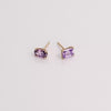 Video of purple gemstone stud earrings on white background.