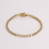 Video of white tennis bracelet on white background.