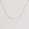 Video of gold chain necklace on white background.