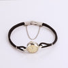 Video of a black rope watch with silver face on white background.