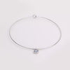 Video of gold collar necklace with gemstone pendant on white background.