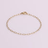 Video of gold chain bracelet on white background.