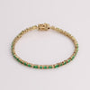 Video of green tennis bracelet on white background.