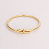 Video of gold bracelet on white background.