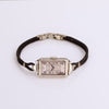 Video of silver watch with black rope band on white background