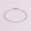 Video of gold chain bracelet on white background.