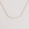 Video of gold chain necklace on white background.