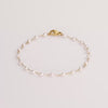 Video of a pearl chain bracelet on white background.