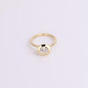 Round Diamond Bezel ring with gold and on white background 