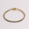 Video of blue tennis bracelet on white background.