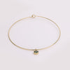 Video of gold collar necklace with gemstone pendant on white background.